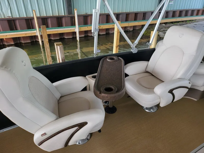 Slide: The Image of 2014 Premier 275 Boundary Waters boat interior with two beige seats and a central table. - 9
