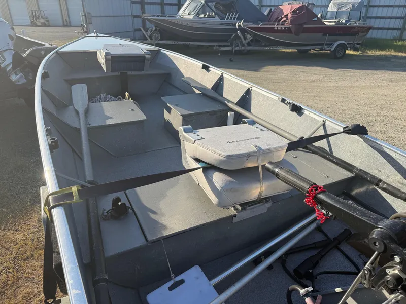 Slide: The Image of 1994 Gregor CH-42L boat with oars and motor, parked outdoors. - 5