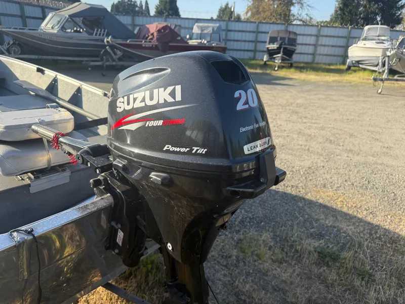 Slide: The Image of Outboard motor on a Gregor CH-42L boat, 1994 model, in a boatyard setting. - 6