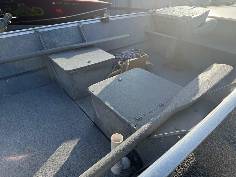 Slide: The Image of Interior of a 1994 Gregor CH-42L boat, featuring storage compartments and seating. - 7