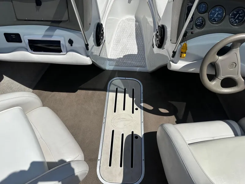 Slide: The Image of 2002 Crownline 180 BR boat interior with steering wheel and seating. - 4