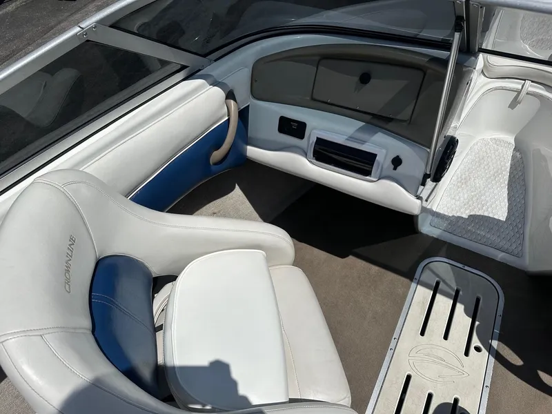 Slide: The Image of Interior of a 2002 Crownline 180 BR boat with white and blue seating. - 5