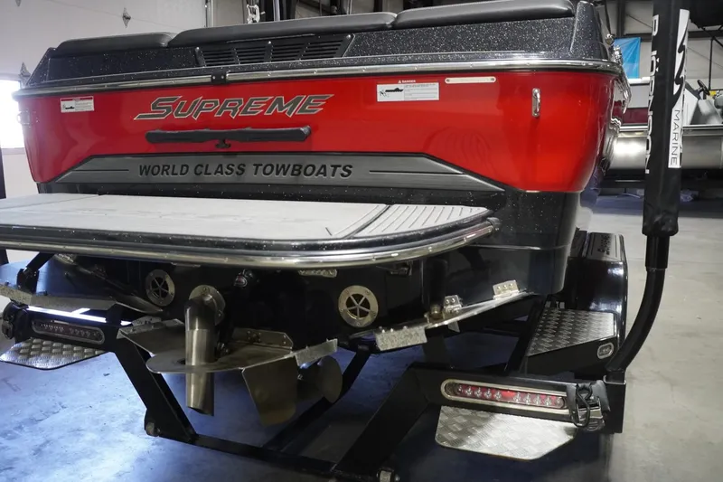 Slide: The Image of 2017 Supreme S211 towboat, red and black, in a garage setting. - 16