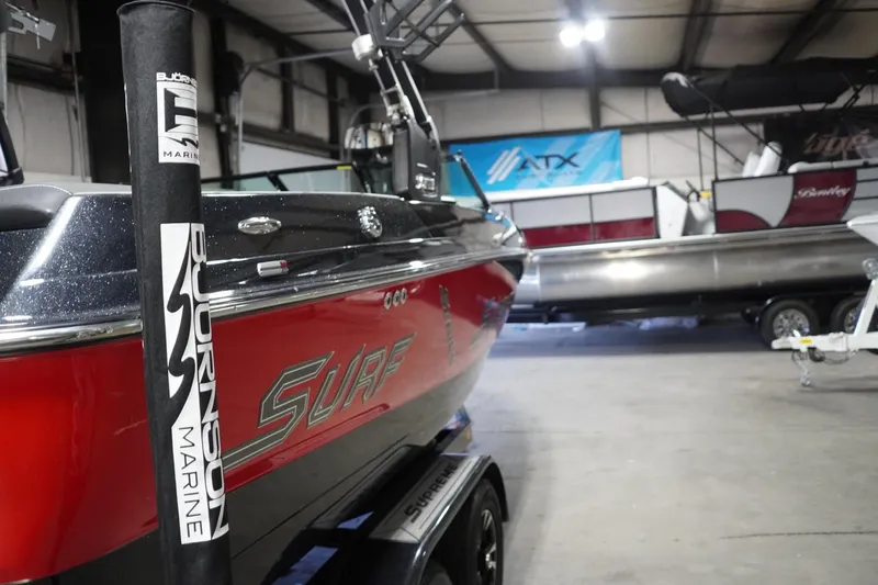 Slide: The Image of Red 2017 Supreme S211 boat in a showroom, featuring sleek design and surf branding. - 17