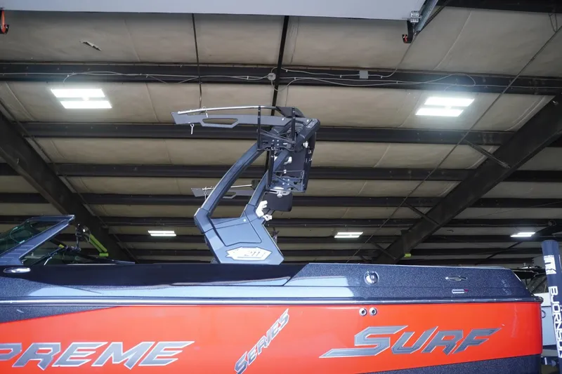 Slide: The Image of 2017 Supreme S211 boat in a warehouse, featuring a sleek red and black design. - 21