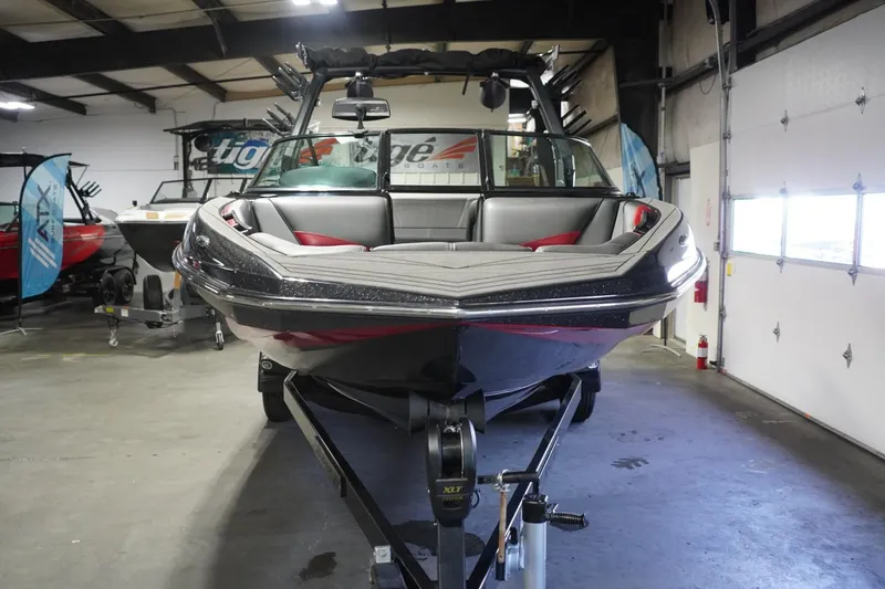 Slide: The Image of 2017 Supreme S211 boat in showroom, front view, on trailer. - 4