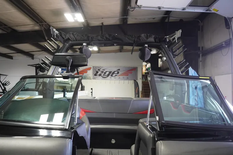 Slide: The Image of 2017 Supreme S211 boat interior with open windshield, showcasing seating and storage racks. - 40