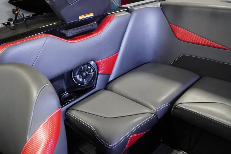 Slide: The Image of 2017 Supreme S211 boat interior with black and red seating, featuring built-in speaker. - 44