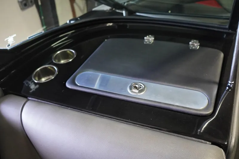 Slide: The Image of Interior of a 2017 Supreme S211 boat with cup holders and storage compartment. - 48