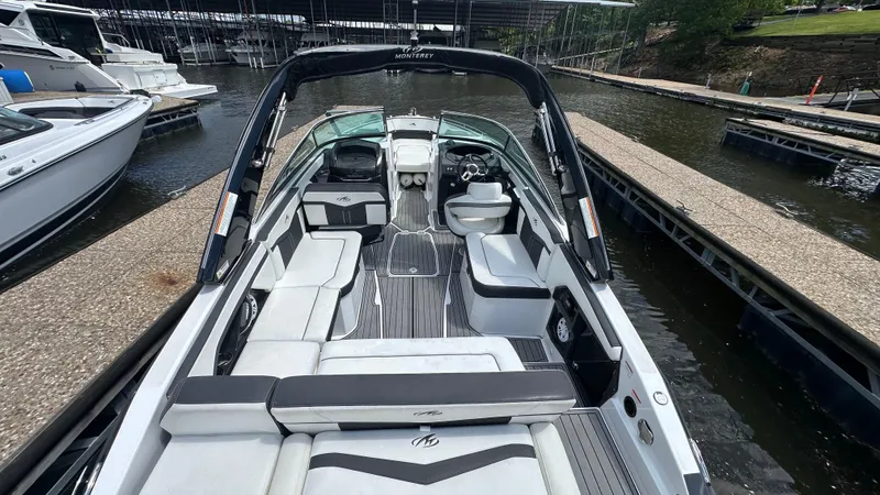 Slide: The Image of 2019 Monterey 278SS boat docked, featuring spacious seating and sleek design. - 3