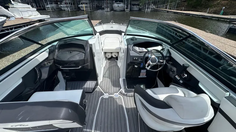 Slide: The Image of 2019 Monterey 278SS boat interior with sleek seating and modern dashboard, docked by the water. - 4