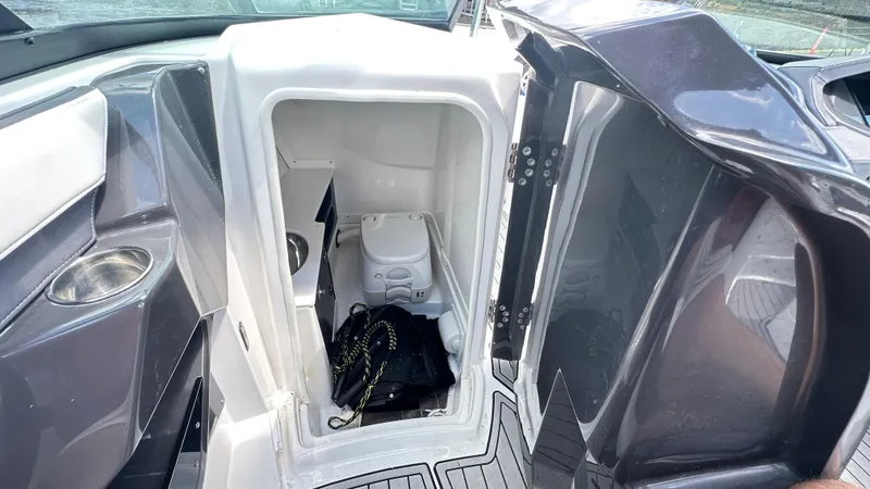 Slide: The Image of 2019 Monterey 278SS boat interior with compact toilet and storage area. - 5