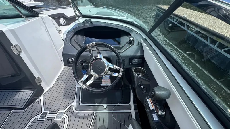 Slide: The Image of 2019 Monterey 278SS boat helm with sleek steering wheel and modern dashboard. - 6