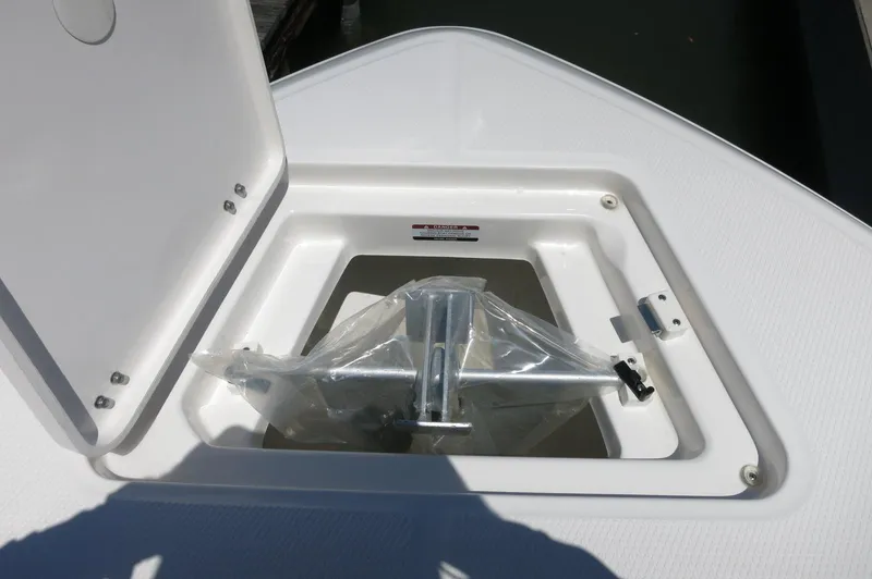 Slide: The Image of 2025 Robalo R230 Center Console anchor compartment with open hatch. - 10