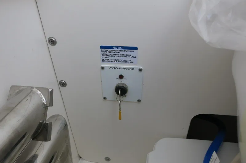 Slide: The Image of 2025 Robalo R230 Center Console boat control panel with key and notice label. - 17