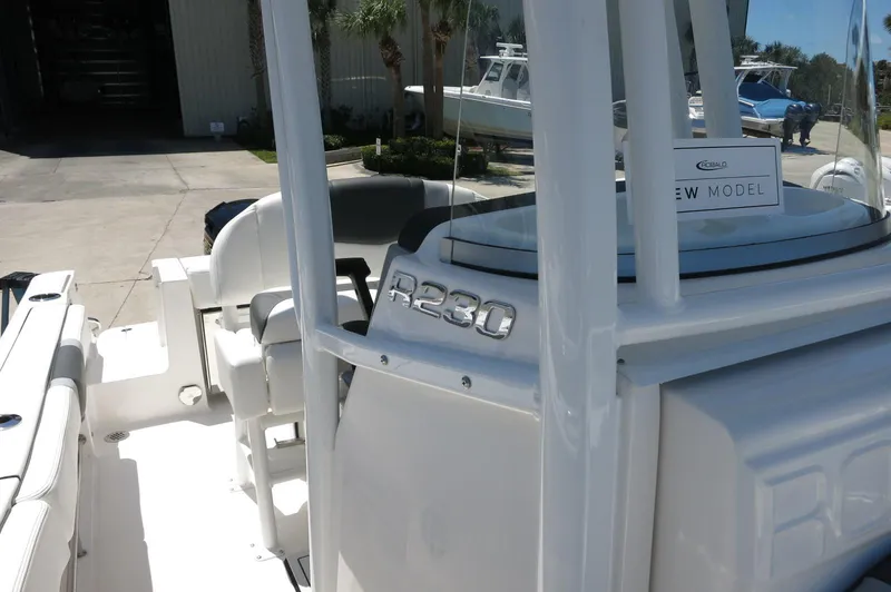 Slide: The Image of 2025 Robalo R230 Center Console boat, white exterior, docked outdoors. - 20