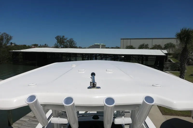 Slide: The Image of 2025 Robalo R230 Center Console boat, docked with clear blue sky background. - 21