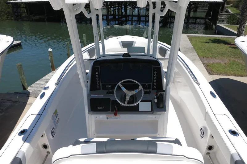 Slide: The Image of 2025 Robalo R230 Center Console boat with sleek helm and modern controls. - 22