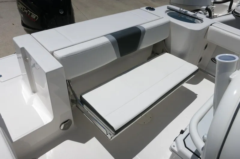 Slide: The Image of 2025 Robalo R230 Center Console boat with foldable seating and sleek white interior design. - 26