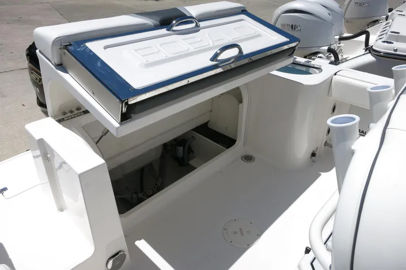 Slide: The Image of 2025 Robalo R230 Center Console boat with open storage compartment. - 27