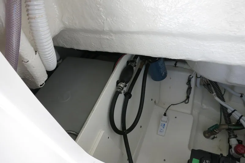 Slide: The Image of 2025 Robalo R230 Center Console interior showing wiring and components. - 30