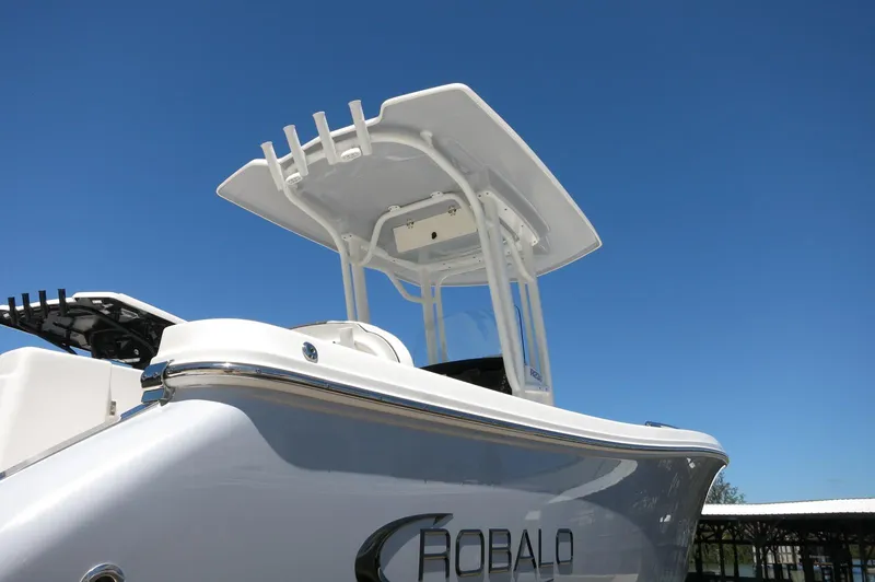 Slide: The Image of 2025 Robalo R230 Center Console boat under clear blue sky. - 4