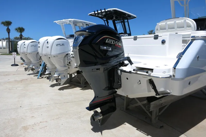 Slide: The Image of 2025 Robalo R230 Center Console boats with Yamaha outboard engines on display. - 5
