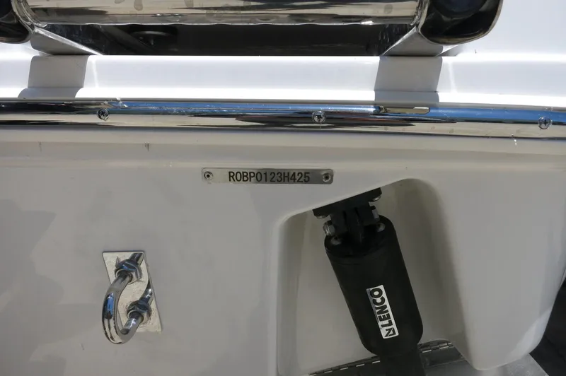 Slide: The Image of 2025 Robalo R230 Center Console boat stern with identification plate and Lenco trim tab. - 7