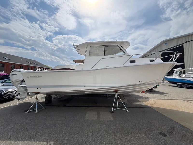 The Image of 2025 NorthCoast 315 HT boat on stands, outdoor display under cloudy sky. - 0