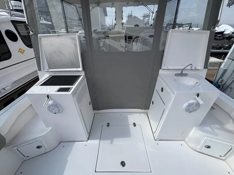 Slide: The Image of 2025 NorthCoast 315 HT boat interior with kitchenette and sink. - 10