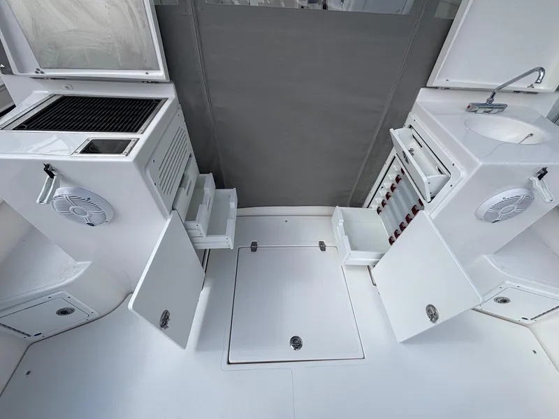 Slide: The Image of 2025 NorthCoast 315 HT boat interior with storage, sink, and grill. - 11