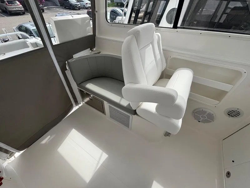 Slide: The Image of 2025 NorthCoast 315 HT boat interior with white seating and modern design. - 14