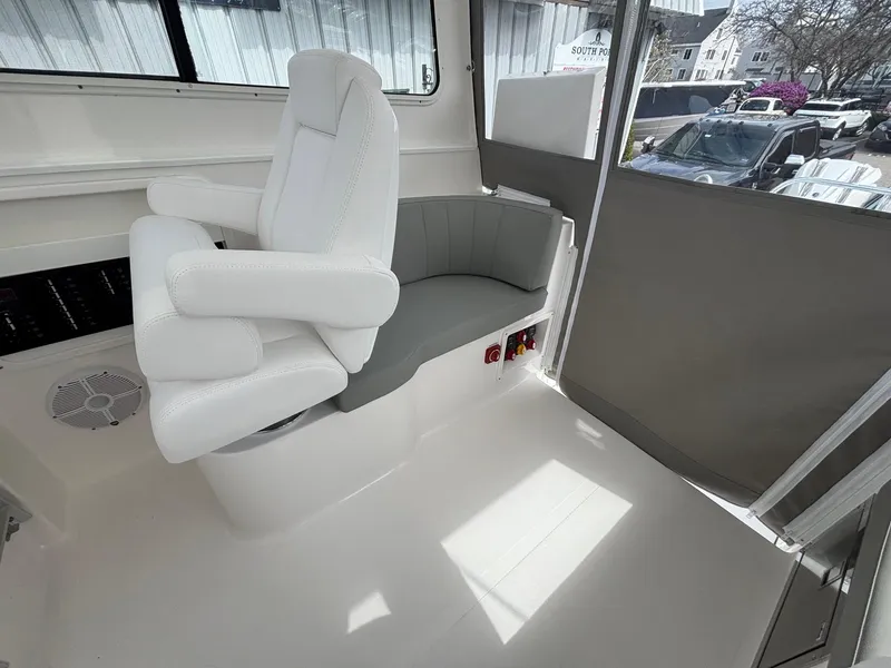 Slide: The Image of 2025 NorthCoast 315 HT boat interior with white seating and modern design. - 15
