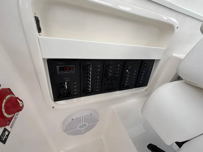 Slide: The Image of Control panel of 2025 NorthCoast 315 HT boat with switches and speaker. - 16