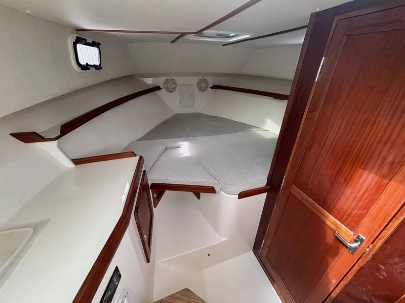 Slide: The Image of 2025 NorthCoast 315 HT cabin interior with wood accents and cozy sleeping area. - 17