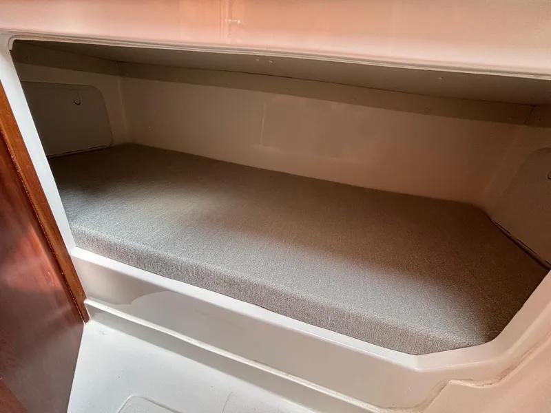 Slide: The Image of 2025 NorthCoast 315 HT cabin interior with cushioned berth. - 19