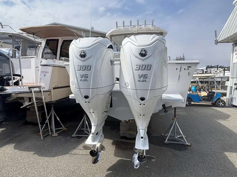 Slide: The Image of 2025 NorthCoast 315 HT boat with twin 300 V6 outboard engines, docked outdoors. - 4