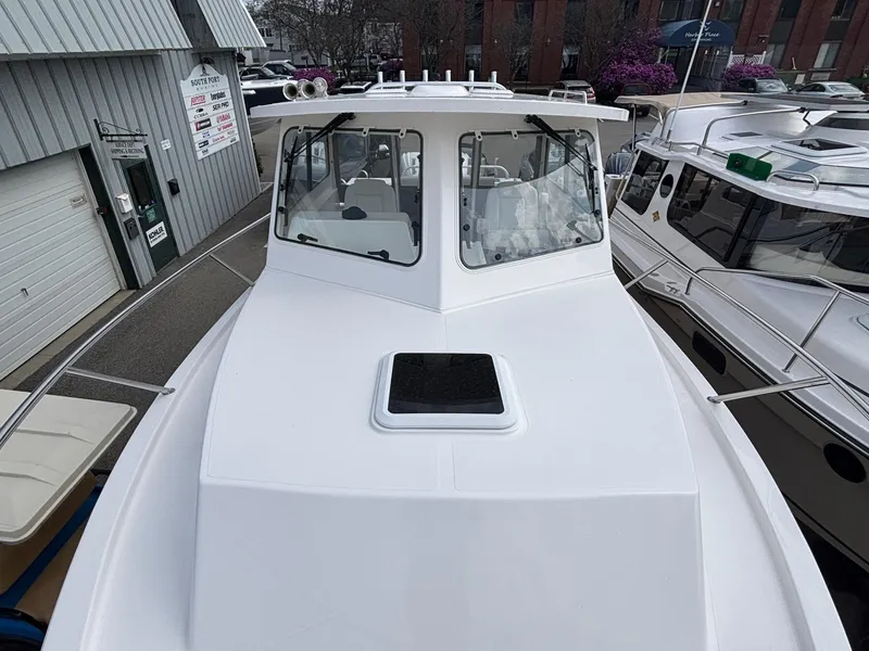 Slide: The Image of 2025 NorthCoast 315 HT boat docked, showcasing sleek design and modern features. - 7