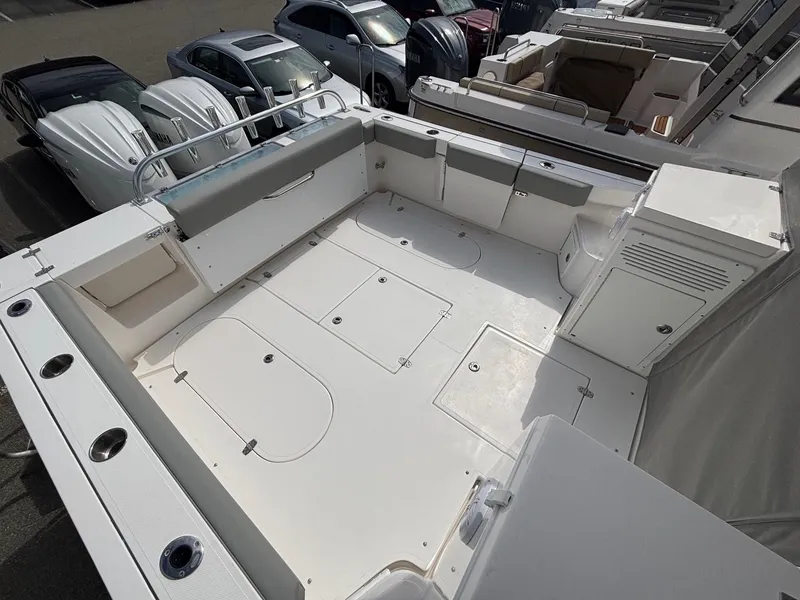 Slide: The Image of 2025 NorthCoast 315 HT boat deck with spacious seating and storage compartments. - 9