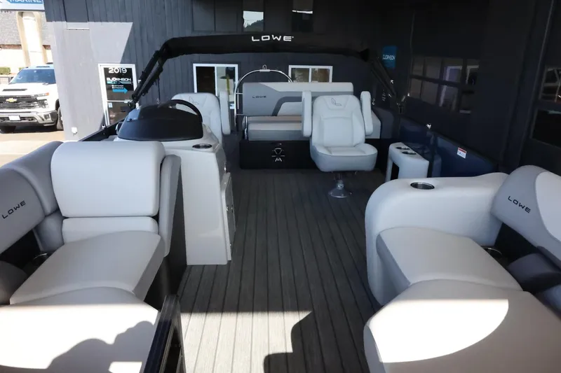 Slide: The Image of 2025 Lowe SS 210 DL pontoon boat interior with plush seating and modern design. - 10