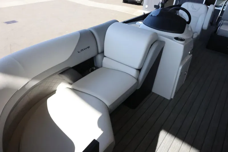 Slide: The Image of 2025 Lowe SS 210 DL boat interior with plush seating and modern helm. - 11