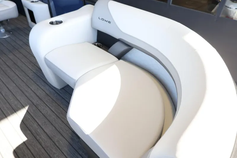 Slide: The Image of 2025 Lowe SS 210 DL boat seating with modern white and gray design on deck. - 12