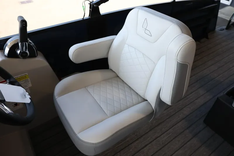 Slide: The Image of 2025 Lowe SS 210 DL boat seat with quilted white upholstery and armrests. - 15