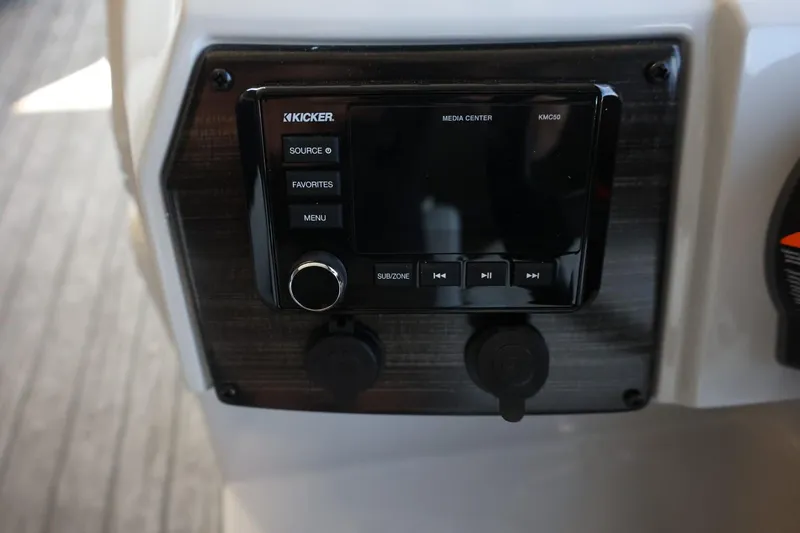 Slide: The Image of 2025 Lowe SS 210 DL boat dashboard with Kicker media center controls. - 17
