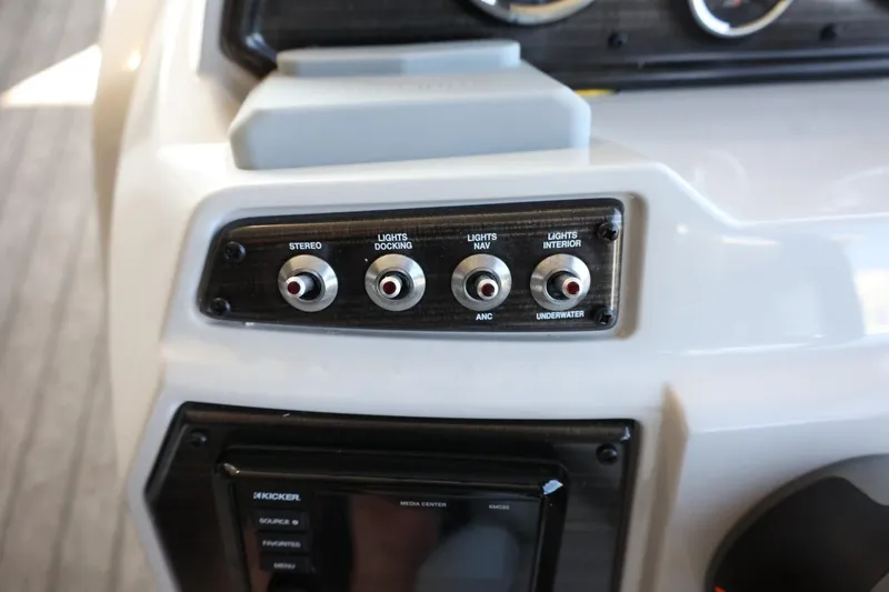 Slide: The Image of Control panel of 2025 Lowe SS 210 DL boat with switches for stereo and lights. - 18