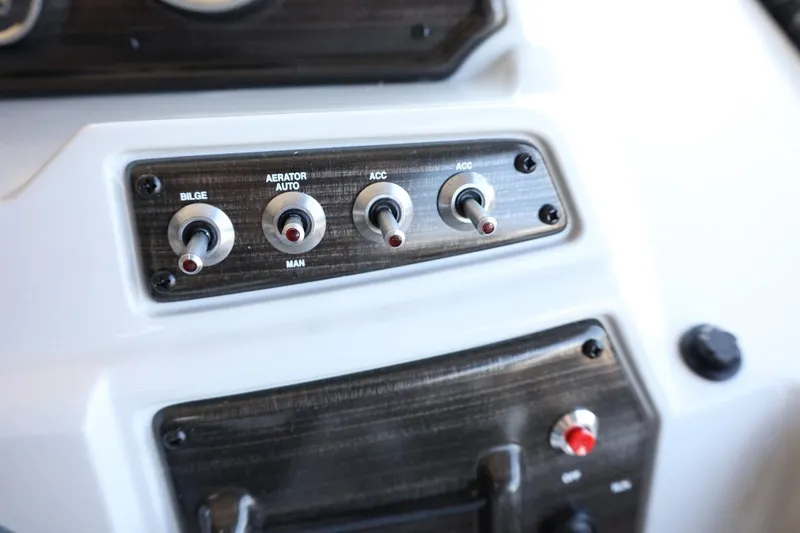 Slide: The Image of Control panel of 2025 Lowe SS 210 DL boat with switches for bilge, aerator, and accessories. - 19