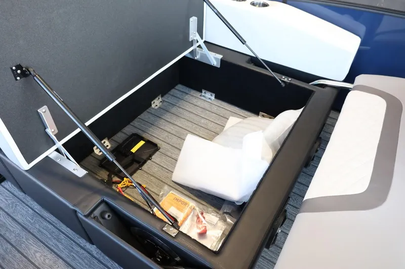 Slide: The Image of Open storage compartment in 2025 Lowe SS 210 DL boat, showing cushions and accessories. - 26