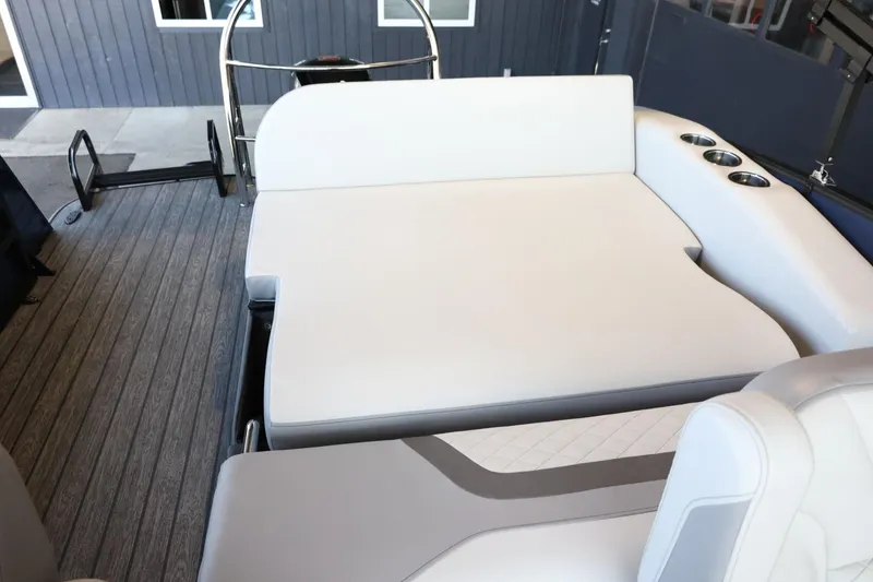 Slide: The Image of 2025 Lowe SS 210 DL boat interior with white seating and cup holders. - 27
