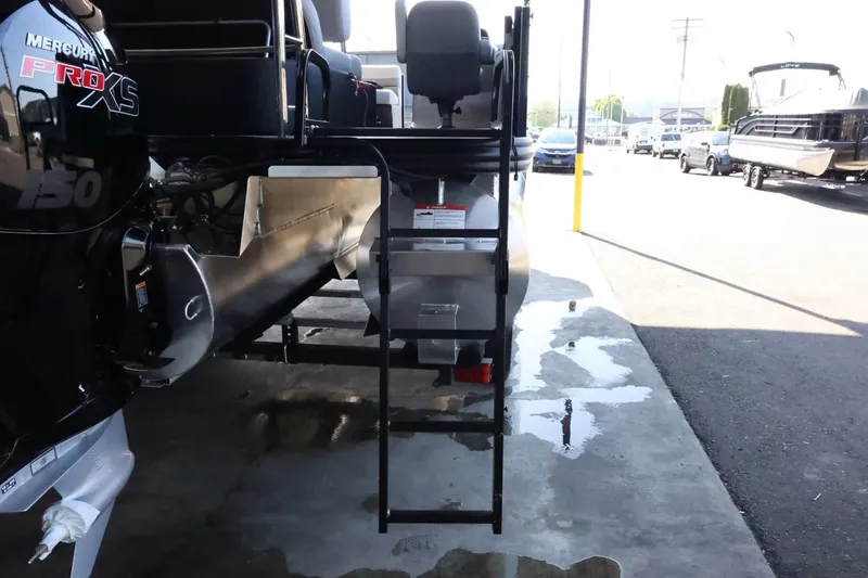 Slide: The Image of 2025 Lowe SS 210 DL boat with Mercury Pro XS engine, docked on wet pavement. - 9