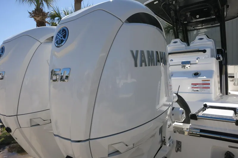 Slide: The Image of 2025 Robalo R250 Center Console with twin Yamaha 150 engines, rear view. - 11